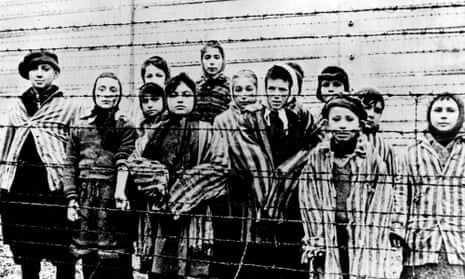 20008772133771537439622 Holocaust children behind barbed wire concentration camp historical photo