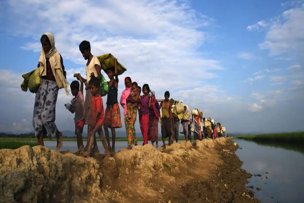 climate refugee Climate refugees walking along a muddy path in rural India due to floods and environmental displacement